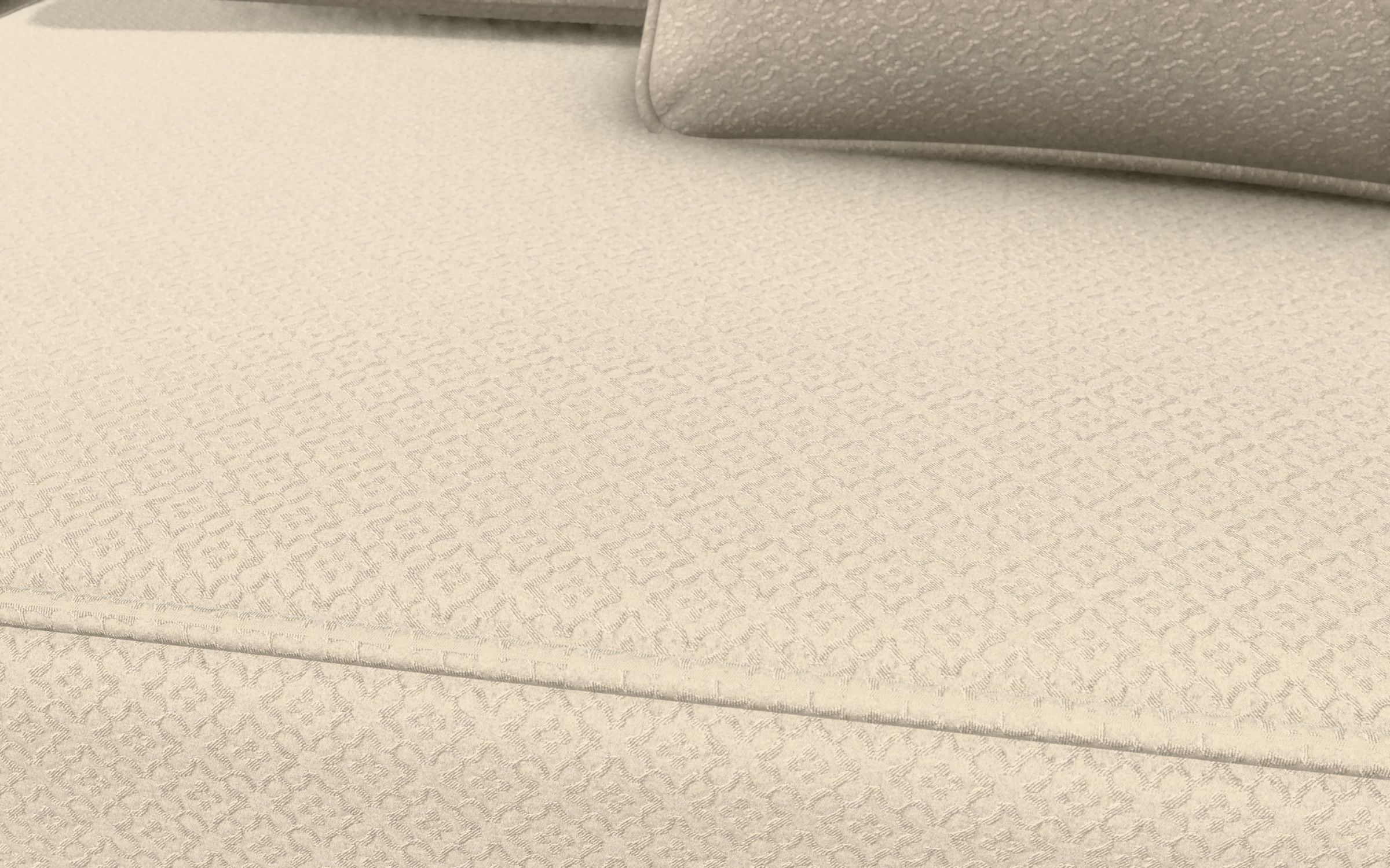 The seat of the sofa at macro distance: the small woven figure of the chenille jacquard, the welt running along the front edge and a cushion at the back.